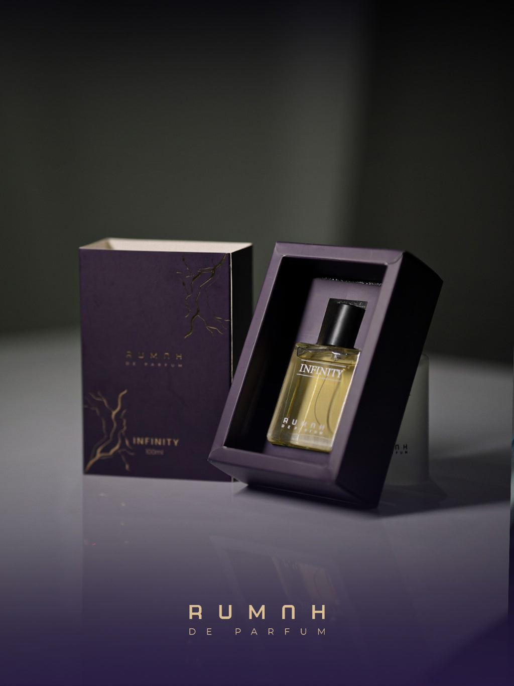Infinity resting in its plum presentation box beside the gold-marbled outer sleeve