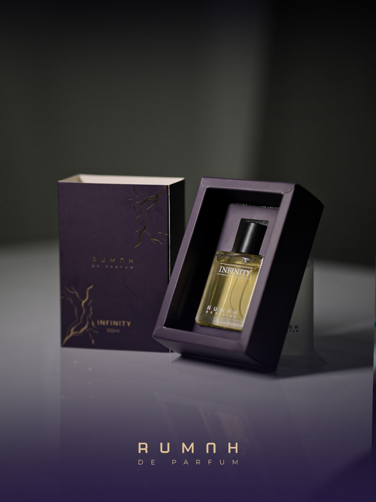 Infinity resting in its plum presentation box beside the gold-marbled outer sleeve