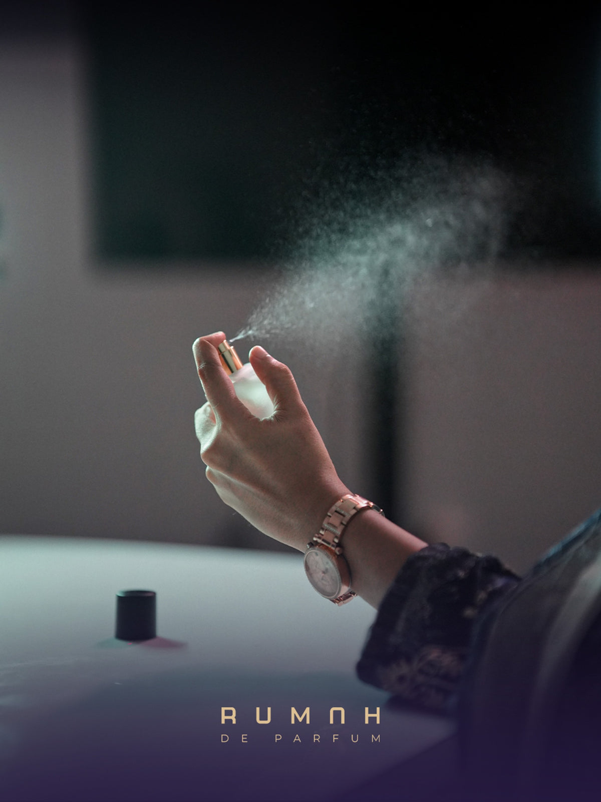 Promise being sprayed, the mist caught in a shaft of light